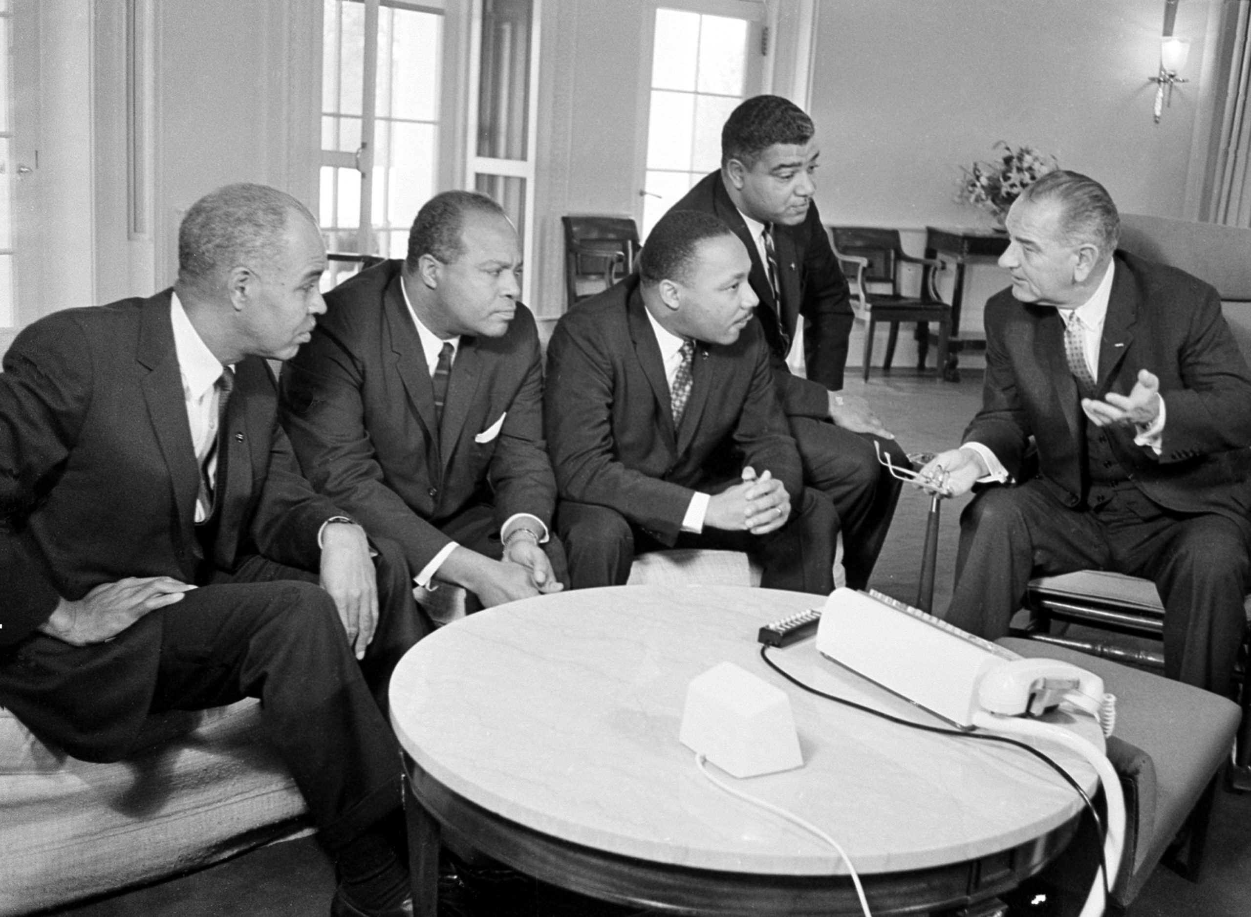U.S. President Lyndon B. Johnson, right, talks with civil rights leaders in his White House office in Washington, D.C., Jan. 18, 1964. The black leaders, from left, are, Roy Wilkins, executive secretary of the National Association for the Advancement of Colored People (NAACP); James Farmer, national director of the Committee on Racial Equality; Dr. Martin Luther King Jr., head of the Southern Christian Leadership Conference; and Whitney Young, executive director of the Urban League. (AP Photo)