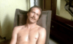 William Hurt is a young man with a moustache, naked and sweaty from the waist up, leaning back