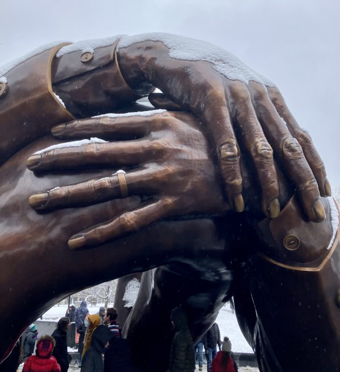 A 12-foot-tall bronze statue of arms embracing