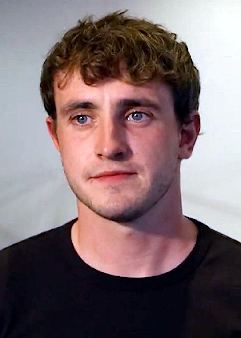Head shot of a young man in a black t-shirt